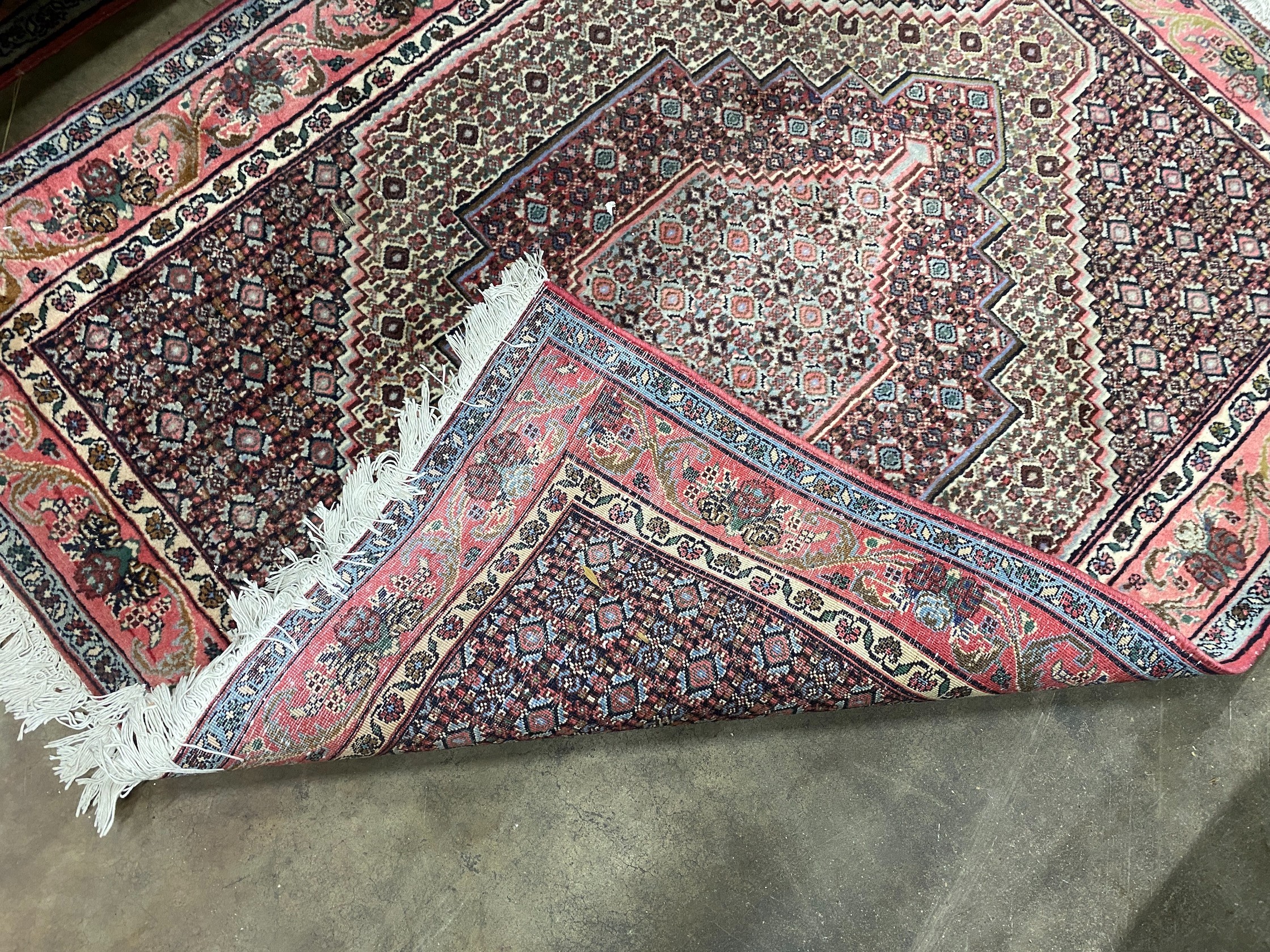 A Senneh blue ground rug, 142 x 122cm